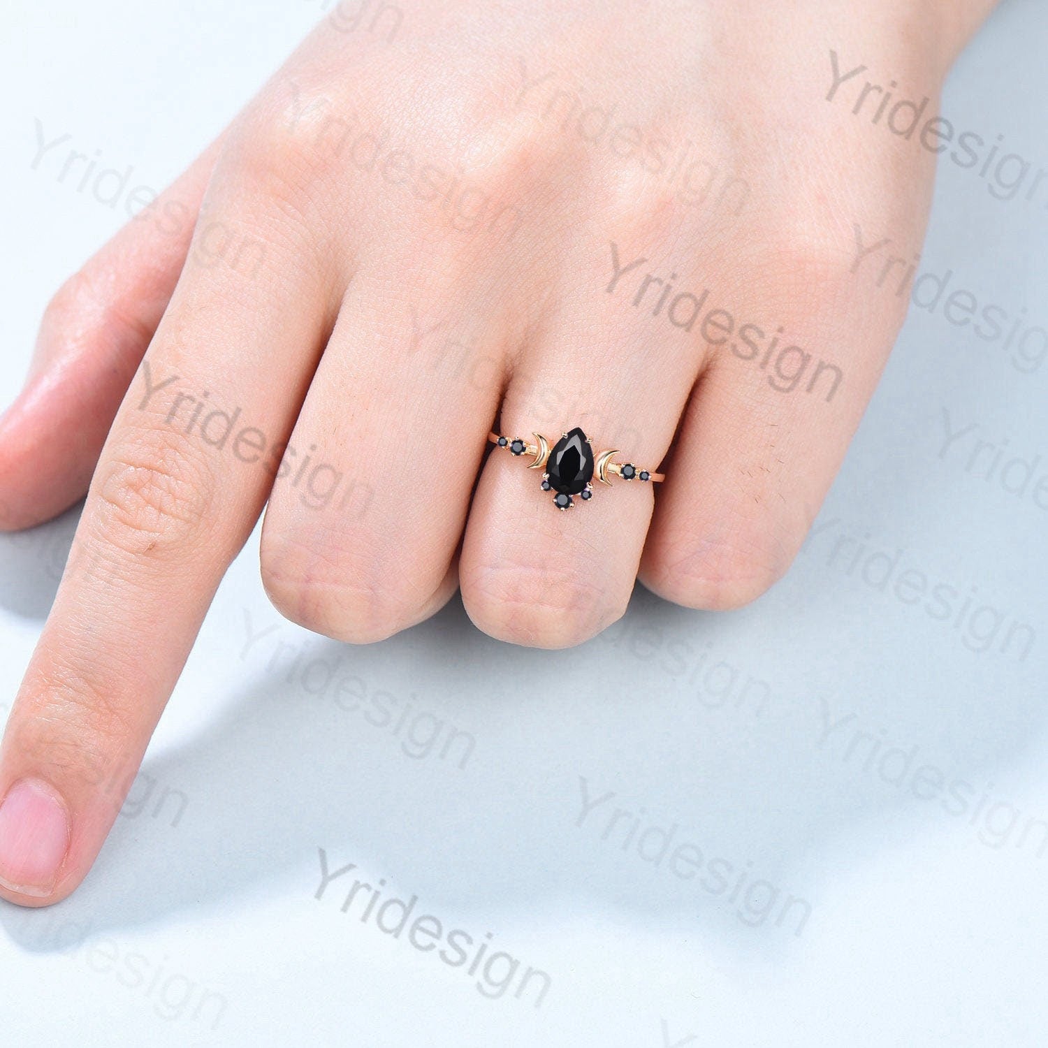 Premium Photo | A black diamond set in a ring is worn by a girl's hand